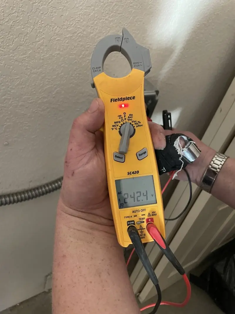 Voltage testing with clamp meter during Whole House Surge Protector in Spring